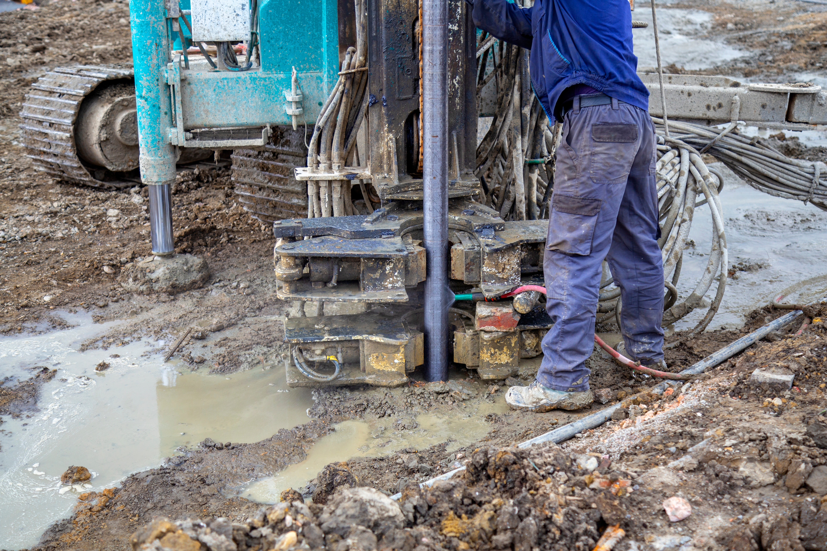 Driller operating a soil sampling rig on site